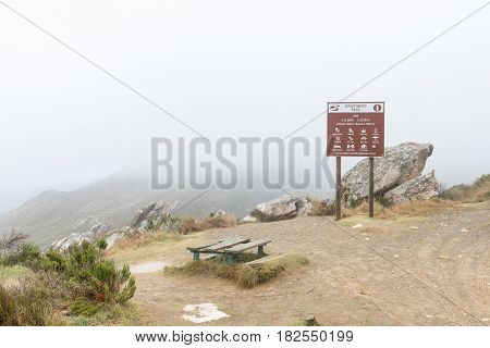 SWARTBERG SOUTH AFRICA - MARCH 24 2017: A picnic spot in the clouds on the historic Swartberg Pass (black mountain pass). The pass is a national monument