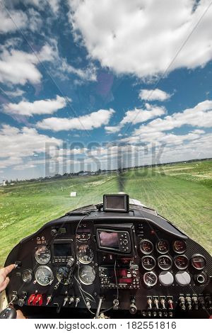 View from the pilot's seat in the cockpit of a light plane while landing