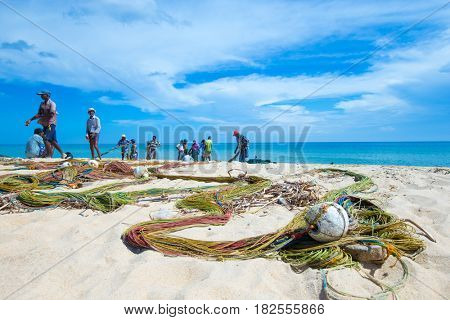 SRI LANKA - Mach 23: Local fishermen pull a fishing net from Indian Ocean on Mach 23, 2017 in Kosgoda, Sri Lanka. Fishing in Sri Lanka is the way they earn their living.