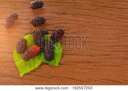 Red Mulberry nature on old wooden table