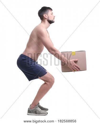 Posture concept. Man lifting heavy cardboard box against white background