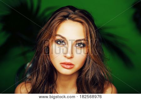 young cute blonde woman on green palm background smiling happy, lifestyle peole concept close up