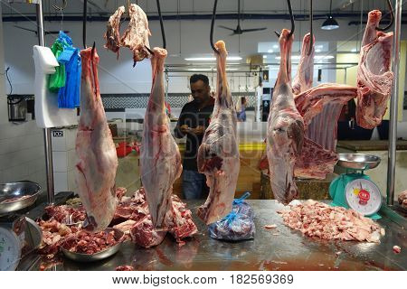 Unidentified Indian Butcher Sits At His Butcher Shop