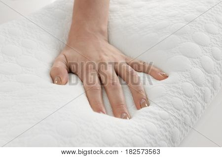 Female hand on orthopedic pillow, closeup