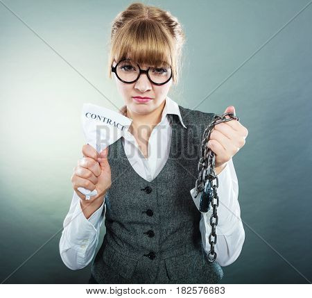 Businesswoman woman ending agreement deal. Young girl holding chain breaking free creasing squeezing paper. Termination breach of contract.