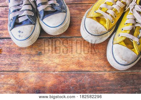 Sneakers on wooden floor dirty convas shoe on old wood