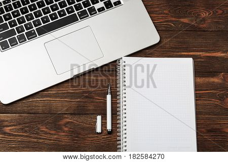 Office workplace with text space. Wooden table with office supplies tablet, coffee, keyboard and book, top view. Modern office workplace. Space for text. Office stuff.