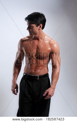 The sexy man is shirtless going for a walk.