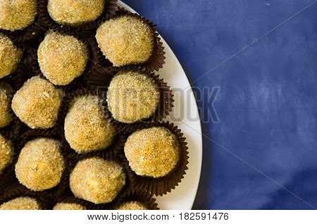 Stacked short pastry potato cookies on blue table