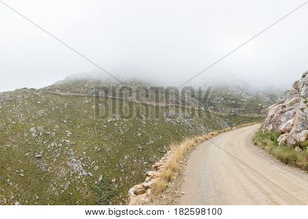 A view of the historic Swartberg Pass (black mountain pass). The pass is a national monument. Four vehicles are visible