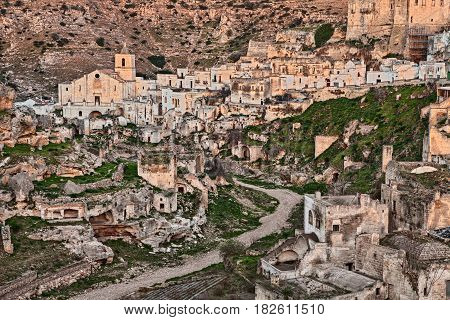Ginosa, Taranto, Puglia, Italy: landscape of the old town with the ancient church and the cave houses carved into the tufa rock