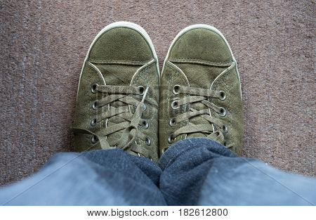 Top View Green deerskin shoes On the carpet
