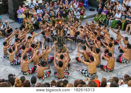 Bali, Indonesia - September 19: Tourists watch traditional Balinese Kecak Dance at Uluwatu Temple on Bali, Indonesia. Kecak (also known as Ramayana Monkey Chant) is very popular cultural show on Bali.