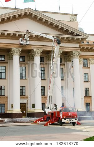 Tyumen, Russia - September 15, 2007: Builders by fire autotower make repair of building facade of Tyumen region Government