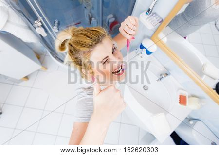 Woman Brushing Cleaning Teeth In Bathroom