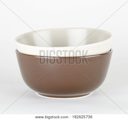 set of white and brown ceramic bowls isolated on white background