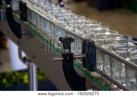 Working process of the production of cucumbers on cannery. Packaging line for processing cucumbers into glass can.