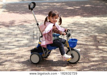 Japanese Girl Riding On The Tricycle (2 Years Old)