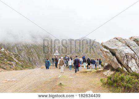 SWARTBERG SOUTH AFRICA - MARCH 24 2017: Unidentified tourists at a viewpoint on the historic Swartberg Pass (black mountain pass). The pass is a national monument