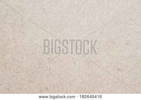 Organic cardboard texture close-up, with various villi, fluff and other inclusions. Natural rough textured paper background