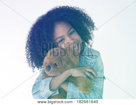 Young girl Cudding teddy bear