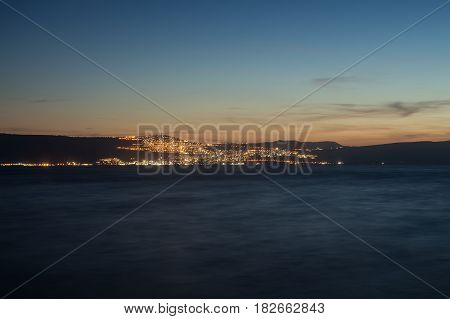 Night view of Tiberias (Tveria) from the opposite shore of Kinneret Lake (Sea of Galilee)
