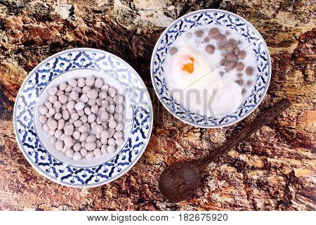 Purple Potato Dumplings With Poached Egg And Coconut Roll In Sweet Coconut Cream .