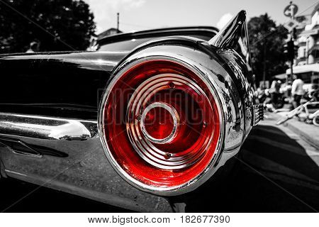 BERLIN - JUNE 05 2016: Stoplight of a personal luxury car Ford Thunderbird (third generation). Close-up. Combined toning. Black-and-white-red. Classic Days Berlin 2016.