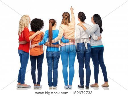 diversity, race, ethnicity and people concept - international group of happy smiling different women over white pointing finger at something