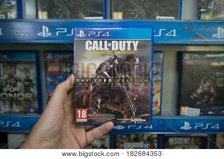 Bratislava, Slovakia, circa april 2017: Man holding Call of Duty Advanced Warfare videogame on Sony Playstation 4 console in store
