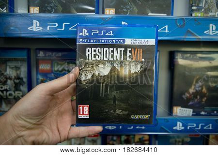 Bratislava, Slovakia, circa april 2017: Man holding Resident Evil 7 videogame on Sony Playstation 4 console in store