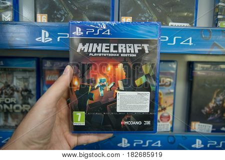 Bratislava, Slovakia, circa april 2017: Man holding Minecraft videogame on Sony Playstation 4 console in store