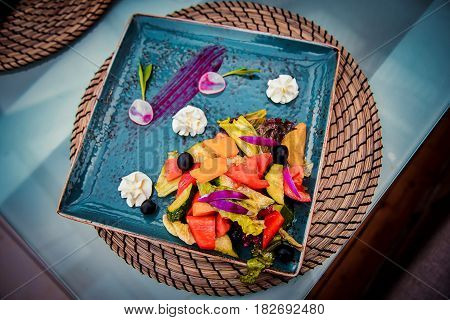Garnished the dish with a delicious vegetable salad on the table