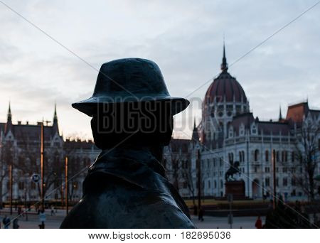 Budapest, Hungary - March 09, 2017: Back view of statue of Imre Nagy and hungarian parliament and square in the distance on sunset
