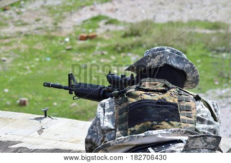Special forces soldier aim target with sub machine gun