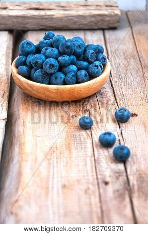 Heap Of Fresh Ripe Raw Bluberries In A Small Wooden Plate On A Wooden Background. Rustic Style And C