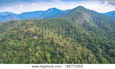 aerial photography above amazing cave. Tham Than Lod Yai is the big cave and have one hole on the top of the cave. it is a short cave there have waterfall pass inside through to another cave
