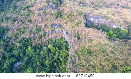 aerial photography above amazing cave. Tham Than Lod Yai is the big cave and have one hole on the top of the cave. it is a short cave there have waterfall pass inside through to another cave