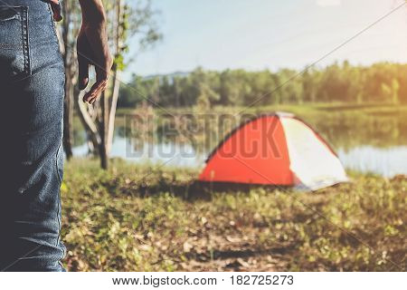 Camping in a forest. Morning scene with tourist tent in green forest near of the lake. Outdoor Lifestyle.selective focus.