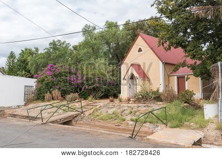 CALITZDORP SOUTH AFRICA - MARCH 24 2017: The St. Marks Chapel of the Anglican Church in Calitzdorp was built in 1880. An irrigation canal is visible next to the street.