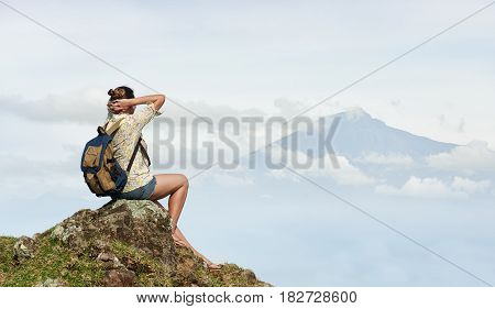 Woman traveller enjoying view at top mountain. Island Lombok Indonesia. Traveling along mountains freedom and active lifestyle concept