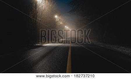 abstract fogy road with lanterns at night