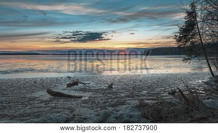 Sunset scene on the frozen lake at sunset