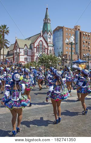 ARICA, CHILE - FEBRUARY 11, 2017: Caporales dancers in ornate costumes performing at the annual Carnaval Andino con la Fuerza del Sol in Arica, Chile.