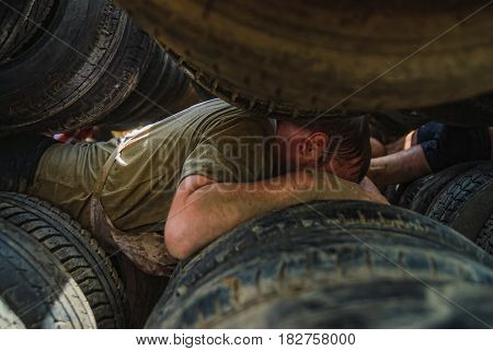 Athlete Moves Between Old Tires. Tyumen