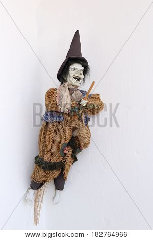 The doll is a witch in old rags. In a hat and flies on a broomstick