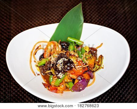 Tiger prawns vegetables Chinese mushrooms and beansprouts in oyster sauce. Dish with shrimps and vegetables. Asian food.