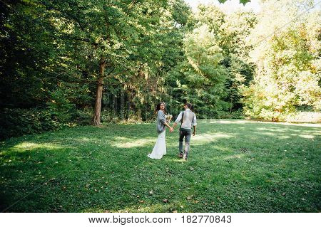 Happy Couple Walking In Summer Park