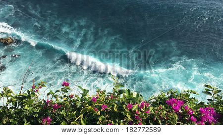 Beautiful blue waves and rocks of the island of Bali