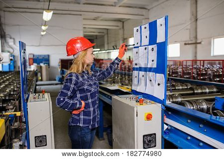 Woman In Red Safety Helmet Work As Industrial Worker